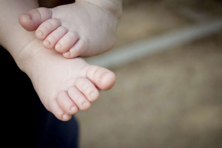 Two month old baby feet on black background. sweet-scene