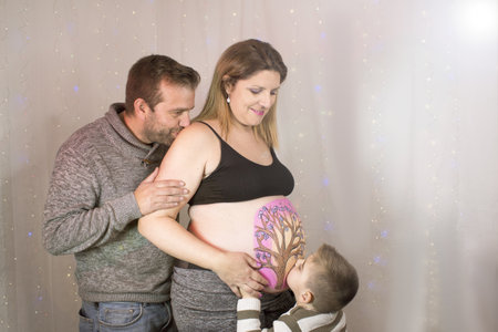 Family scene with pregnant mother, father and little son. No copy spaceの写真素材