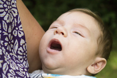 Two month old baby about to start crying. Not happy expressionの写真素材