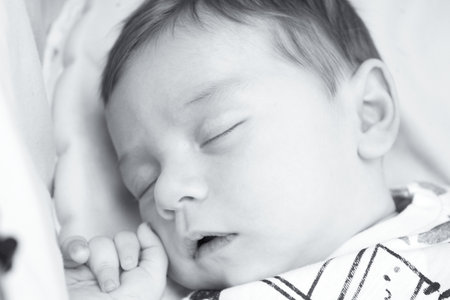 Sleeping two month old baby. Close your eyes.の写真素材