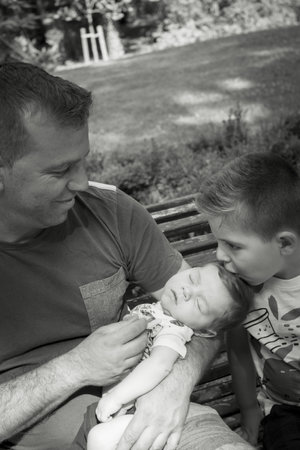 Four year old boy kissing his two month old brother. sweet scenesの写真素材