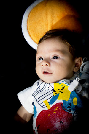 Two month old baby lying on a towel. Happy expressionの写真素材