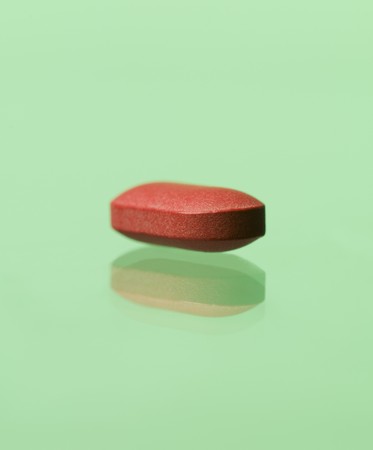 red pill toward green backgroundの写真素材