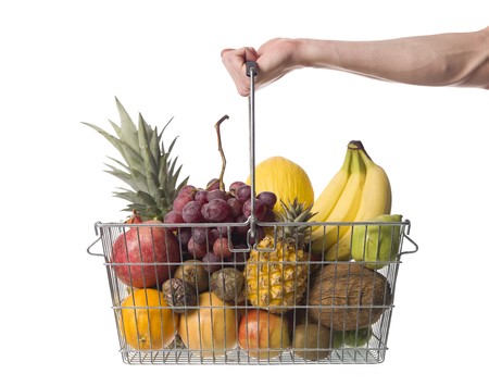 Holding a shopping-basket of fruitの写真素材