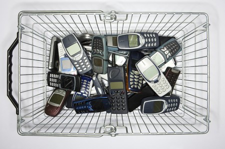 Cellphones in a shopping-basketの写真素材