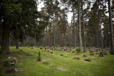 A cemetery at day time with lots of tombstonesの写真素材