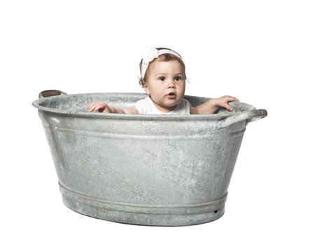 Baby in a bucket isolated on whiteの写真素材