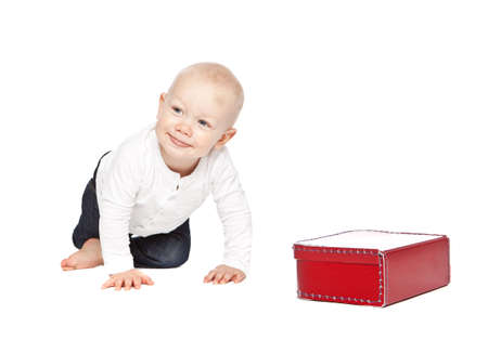 A boy and his red lunchbox isolated on a white backgroundの写真素材