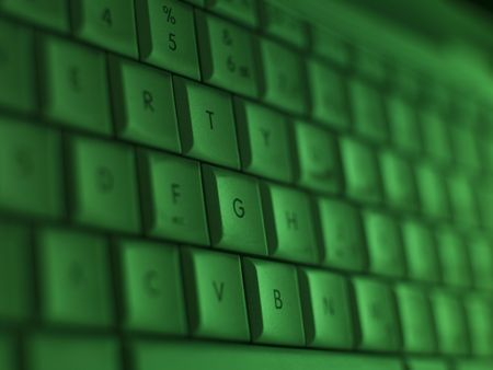 Closeup on a keyboard with a green toneの写真素材