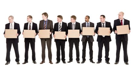 Men in a row holding signs isolated on white backgroundの写真素材
