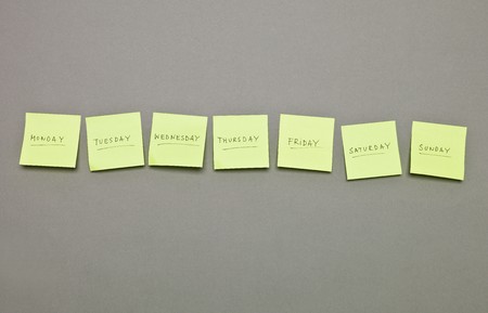 Adhesive Notes with the weekdays in a row on grey background