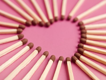 Matches formed as a heart on pink backgroundの写真素材