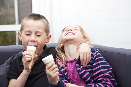 Happy Siblings eating ice-creamの写真素材