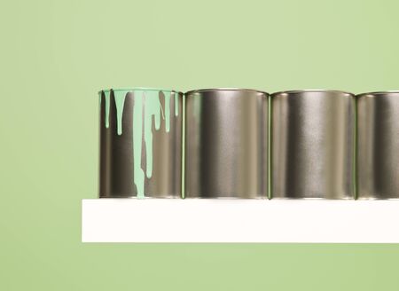 Paintcans in a row on green backgroundの写真素材