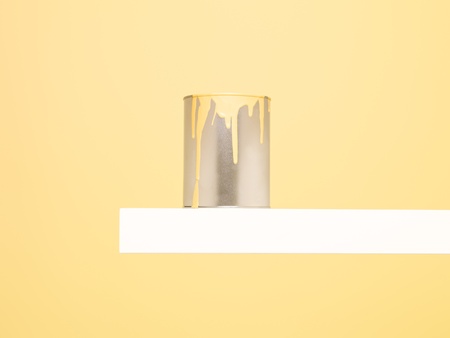 Paintcan with spill on yellow backgroundの写真素材