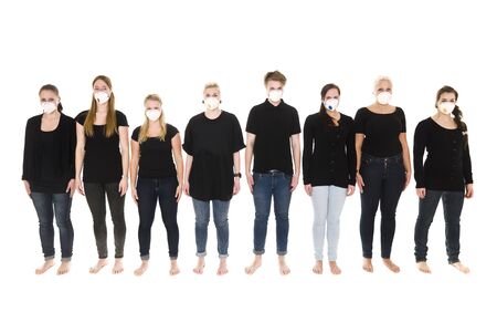 Girls in a row with Protective Masks isolated on white backgroundの写真素材