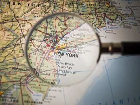 Magnifying Glass in front of a New York mapの写真素材