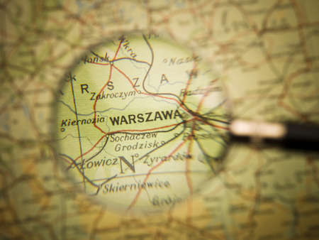 Magnifying Glass in front of a Warzawa map