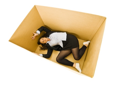 Afraid Woman in a cardboard box isolated on white backgroundの写真素材