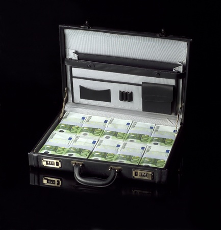 Briefcase with money isolated on black backgroundの写真素材