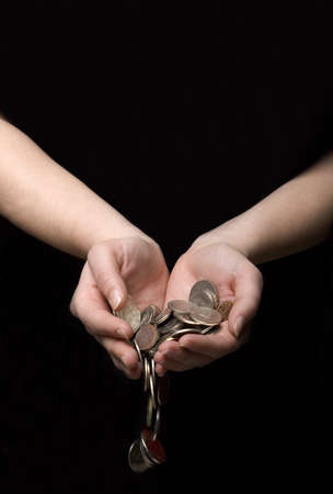 Coins flowing out of handsの写真素材