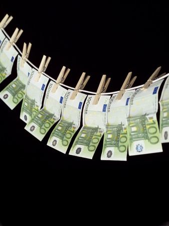 Laundering money towards black backgroundの写真素材
