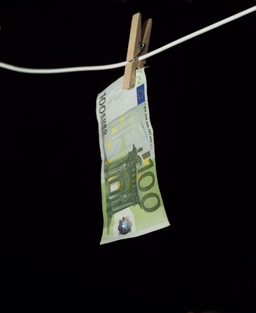 Laundering money towards black backgroundの写真素材