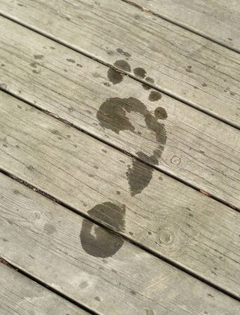 Wet Footprint on the dry pierの写真素材
