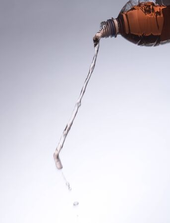 Pouring Red Lemonade from a bottleの写真素材