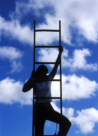 Silhouette of a woman climbing the ladderのeditorial素材