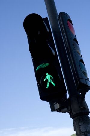 Green Traffic Light towards blue skyの写真素材