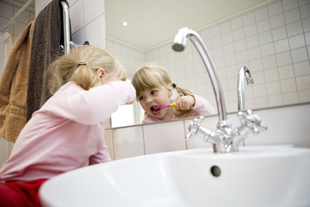 Baby Girl with toothbrush in the bathroomの写真素材