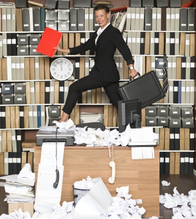 Happy Businesswoman at a messy officeの写真素材