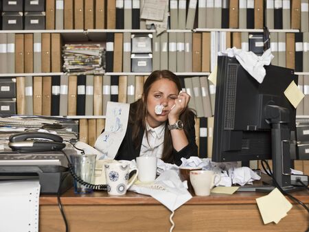 Businesswoman with the flu at the officeの写真素材