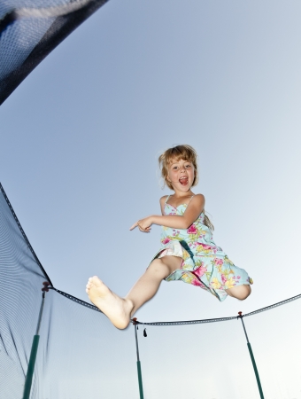 Young Girl Jumping in a trampolineの写真素材
