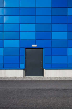 Locked door on blue wallの写真素材