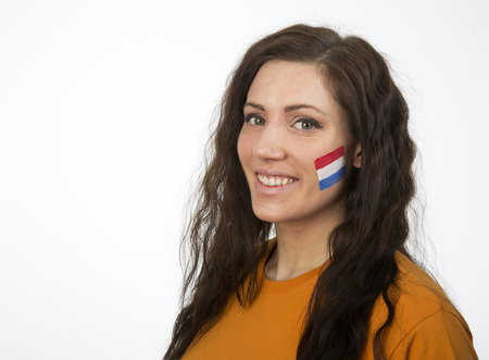 Young Girl with the Dutch flag painted in her faceの写真素材