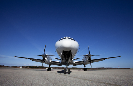Airplane on the ground in front of blue sky