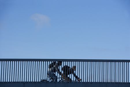 Bicycle Commuters on a Railing of bridgeの写真素材
