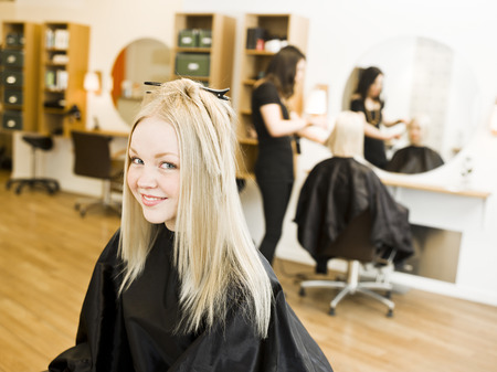 Young Blond Girl in the Hair Salonの写真素材