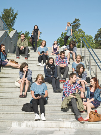 Large group of people sitting in the stairsの写真素材