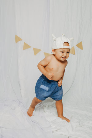 First Birthday Boy in happy face with dancing and smiling. With no t-shirtの写真素材
