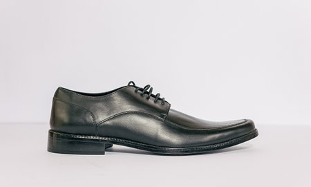 Men's black leather shoes on a white background. Studio shot.の写真素材