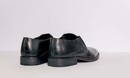 Black men shoes on the white background. Able to added text on the side.の写真素材