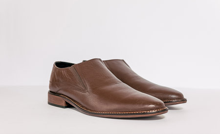 Men's brown leather shoes on a white background. Studio shot.の写真素材