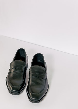 Black men shoes on the white background. Able to added text on the side.の写真素材