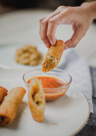 Lumpia or lunpia, traditional snacks from Semarang, Central Java, Indonesia. Traditional spring rolls contain stir-fried bamboo shoots (rebung), eggs, and chicken or shrimpの写真素材