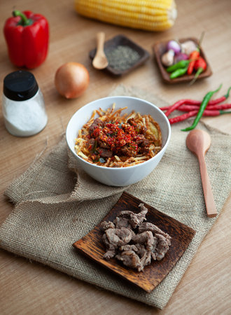 Cumi Pedas is a authentic recipe from Indonesia. Squid is the main ingredients of this menu. Served with rice, peppers, chilli and spoon.の写真素材