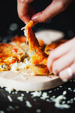 Mini pizzas, vegetarian pizzas with the addition of tomatoes, mushrooms, olives, cheese and fresh...