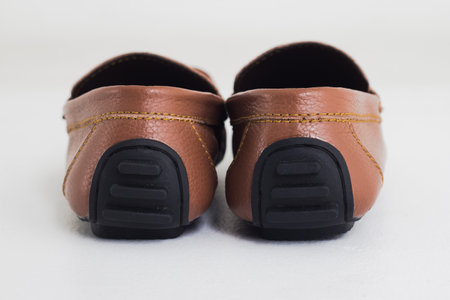A pair of brown shoes isolated on a white studio background.の写真素材